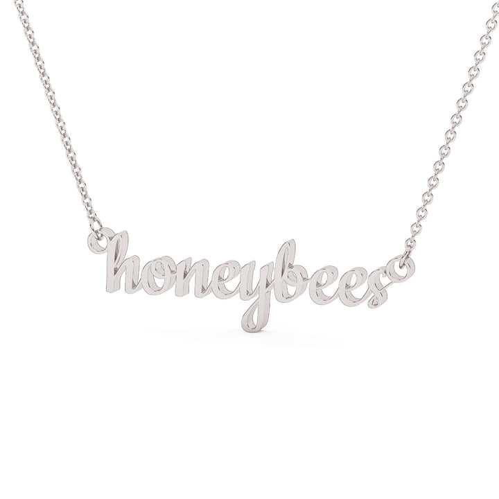 This is a Stephenville ISD pendant made from the word honeybees in a script font made in stainless steel in a white gold color.