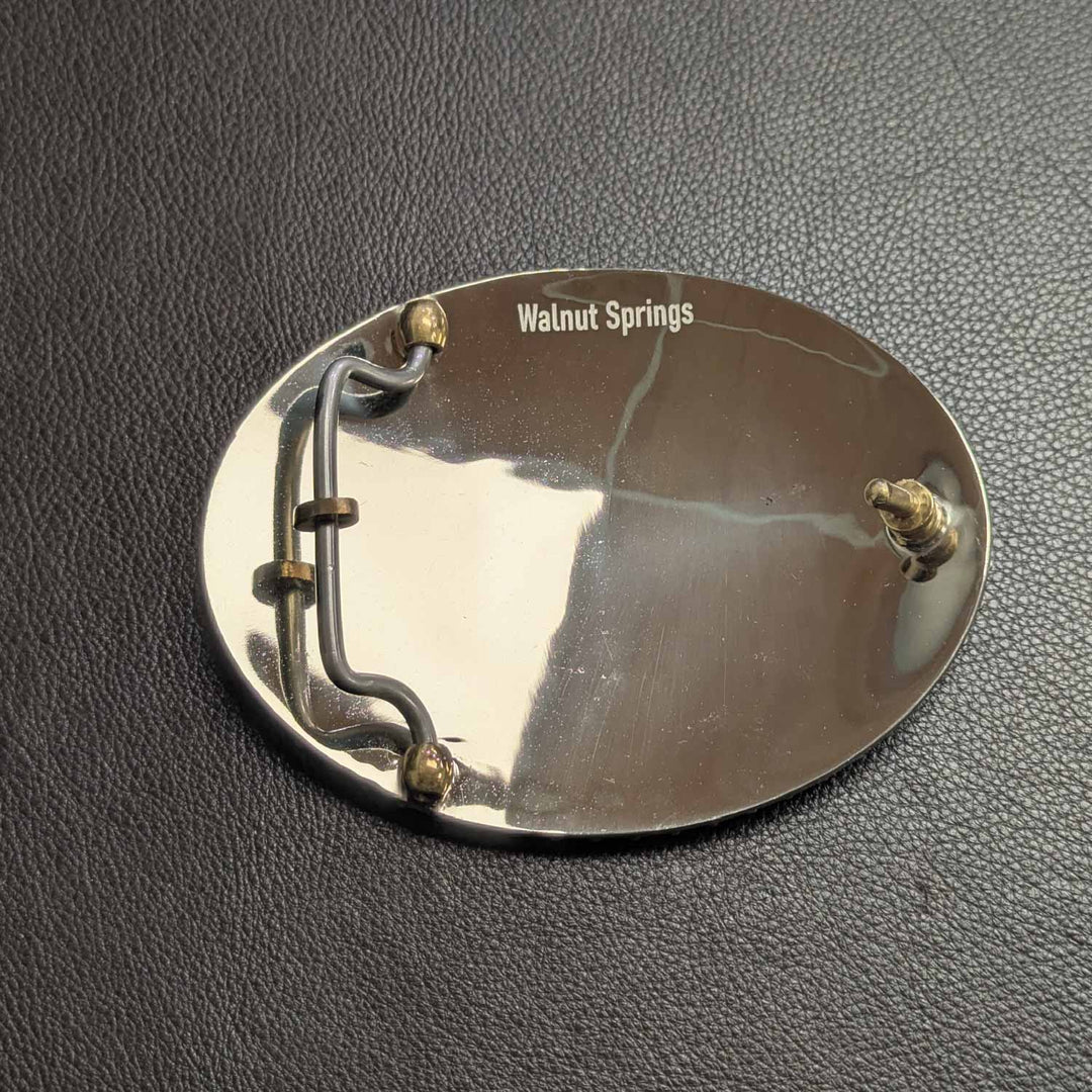 This is the high polish back of a Tarleton State University belt buckle featuring the STU logo. Crafted in German silver, bronze, and copper.
