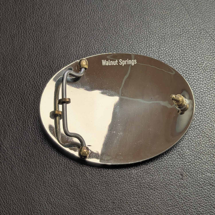 This is the high polish back of a Tarleton State University belt buckle featuring the STU logo. Crafted in German silver, bronze, and copper.