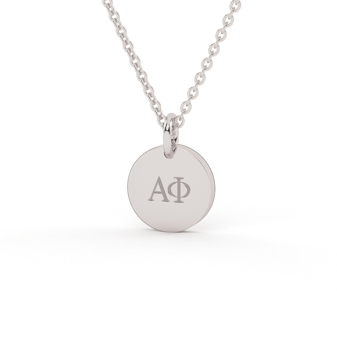 This is a small white stainless steel disc with the Greek letters Aplha Phi Engraved on the front. 