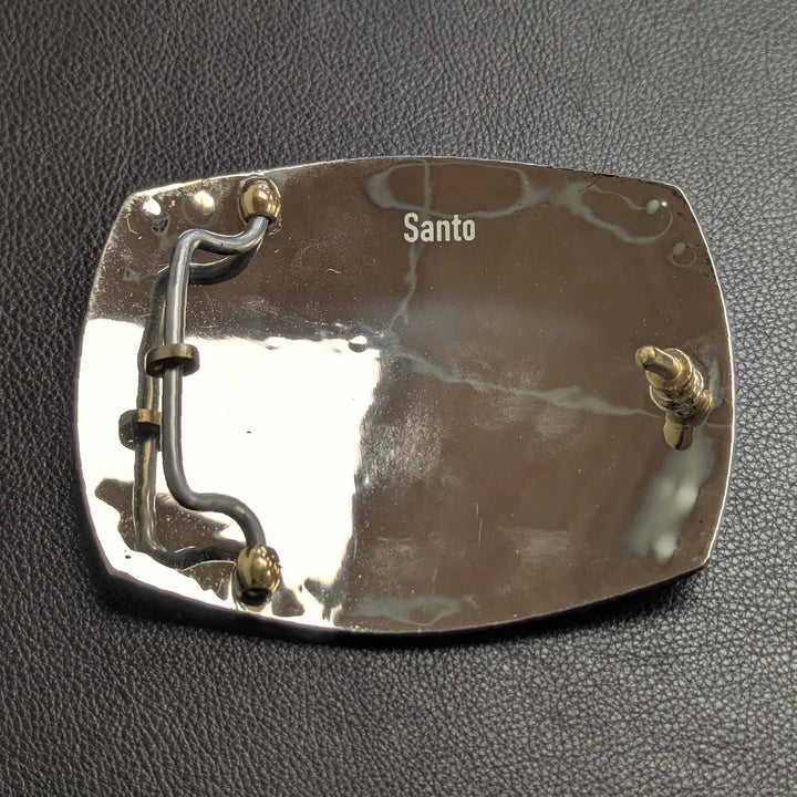 This is the back of a Tarleton State University belt buckle featuring the Rider in Texas logo. Crafted in German silver with purple cubic zirconia, bronze words and copper scrollwork. 