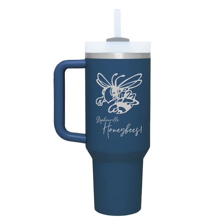 This is an insulated engraved stainless steel tumbler with a handle. The engraved image is the Stephenville Honeybees logo. The cup is demin in color. 
