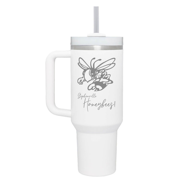 This is an insulated engraved stainless steel tumbler with a handle. The engraved image is the Stephenville Honeybees logo. The cup is white in color. 