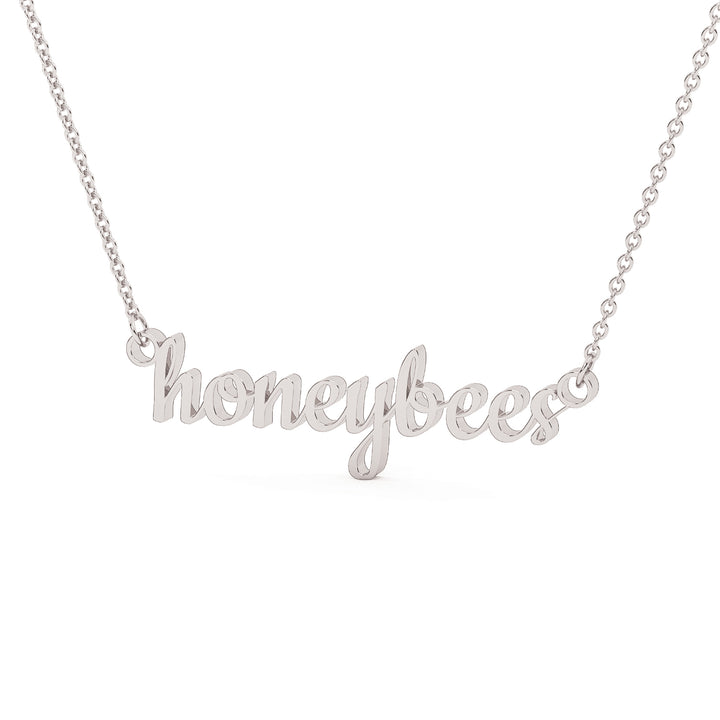 This is a Stephenville ISD pendant made from the word honeybees in a script font made in stainless steel in a white gold color. 