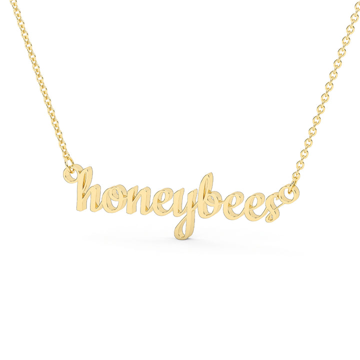 This is a Stephenville ISD pendant made from the word honeybees in a script font made in stainless steel in a gold color. 